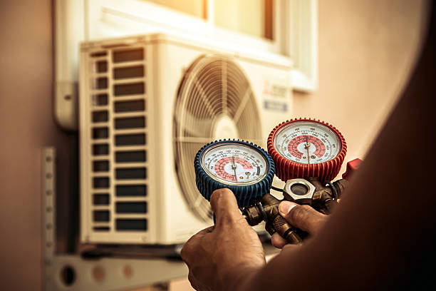 Professional Air Conditioning Service technician working in Fulton, MO